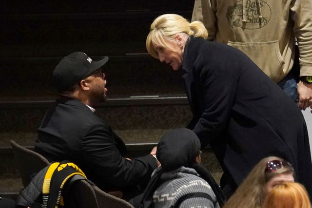 Activist Erin Brockovich talks to a resident of East Palestine before speaking at a town hall meeting at East Palestine High School concerning the February 3 Norfolk Southern freight train derailment in East Palestine, Ohio