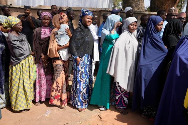People queue to cast their votes during the presidential and parliamentary elections in Yola, Nigeria