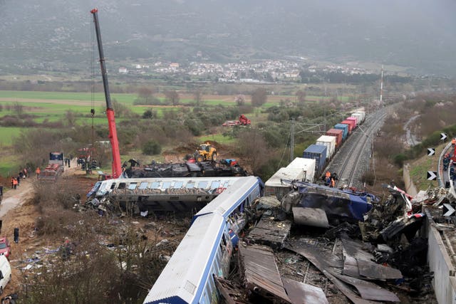 A crane operator, firefighters and rescuers work the scene of a collision in Tempe, about 376 kilometers (235 miles) north of Athens, near Larissa city, Greece 