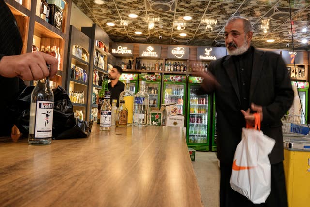 A man buys alcohol in Baghdad