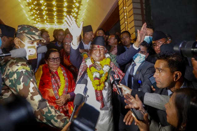 Nepali Congress party leader Ram Chandra Poudel waves to the media after being elected Nepal’s new president