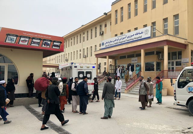 People stand outside a hospital after the blast