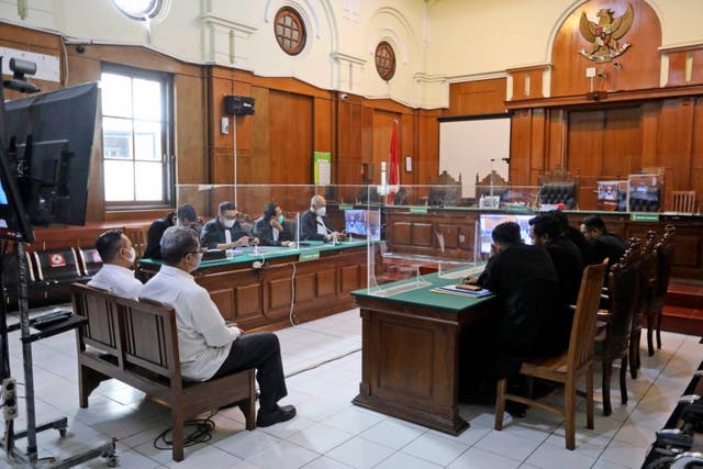 Arema FC organising committee chairman Abdul Haris, second left, and the club’s security chief Suko Sutrisno, far left, sit during their sentencing hearing