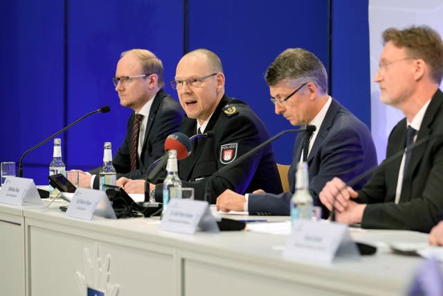 Matthias Tresp of the Hamburg police, second from left, talks to the media