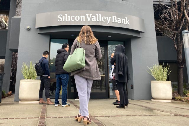 People stand outside a Silicon Valley Bank branch in Santa Clara, California, in March