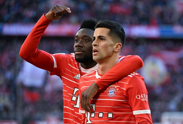 Joao Cancelo (right) and Alphonso Davies celebrate