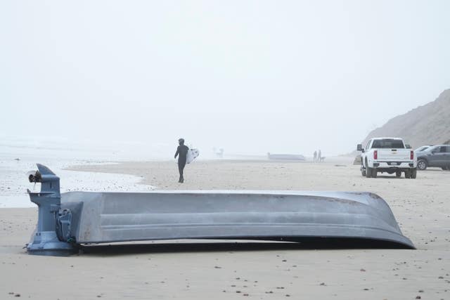A boat sits overturned on Black's Beach in San Diego