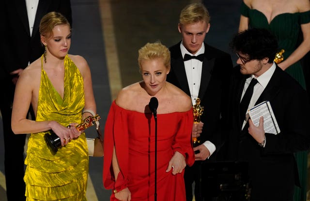 Yulia Abrosimova, second from left, and members of the crew from Navalny accept the award for best documentary feature film at the Oscars at the Dolby Theatre in Los Angeles