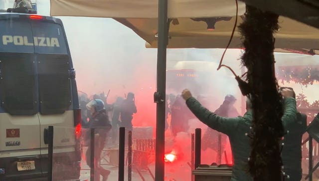 Riot police clashes with Eintracht Frankfurt supporters on the street, ahead of the Champions League match at Napoli