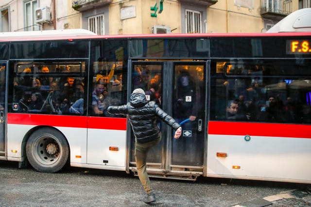 A Napoli supporter kicks a bus carrying Eintracht Frankfurt fans