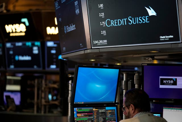 A sign displays the name of Credit Suisse on the floor at the New York Stock Exchange in New York