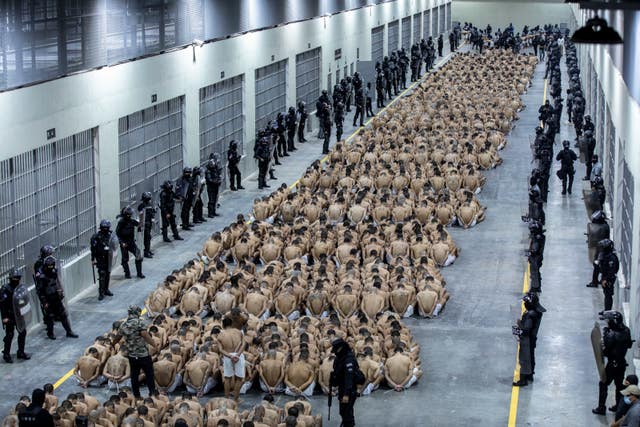 Inmates identified by authorities as gang members are seated on the prison floor of the Terrorism Confinement Centre in Tecoluca, El Salvador