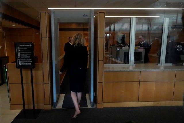Holmes walks through security as she arrives at federal court in San Jose