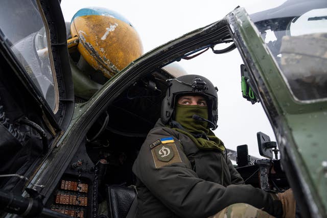 A Ukrainian pilot prepares for a flight on his Mi-24 attack helicopter during during a combat mission in Donetsk region, Ukraine