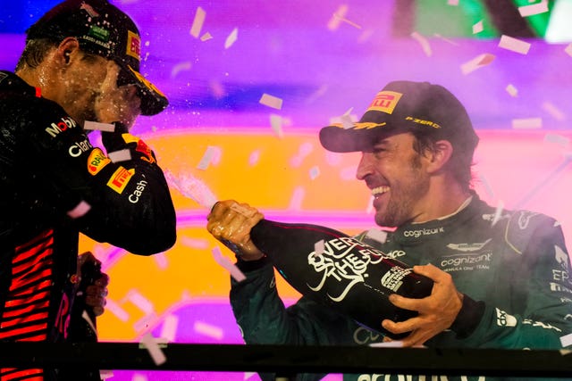 Fernando Alonso (right) celebrates on the podium