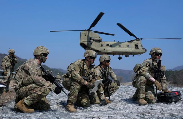 US Army soldiers wait to board their CH-47 Chinook helicopter during a joint military drill with South Korea and the United States in Pocheon, South Korea, Sunday, March 19, 2023 (Ahn Young-joon, File/AP)