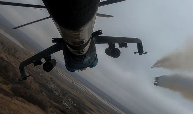 A Ukrainian Mi-24 attack helicopter fires missiles towards Russian positions during a combat mission in Donetsk region, Ukraine