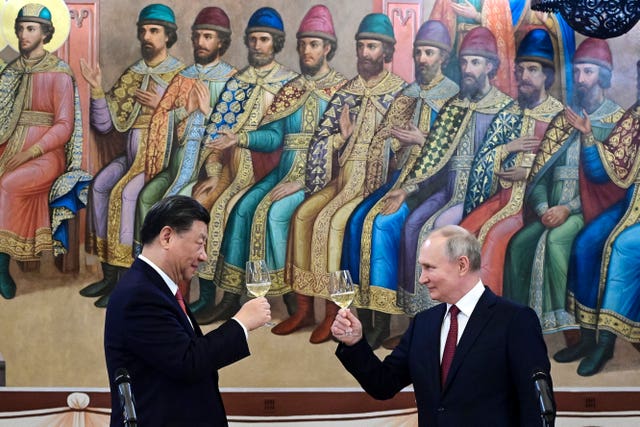 Russian president Vladimir Putin, right, and Chinese president Xi Jinping toast during their dinner at The Palace of the Facets in the Moscow Kremlin in Russia