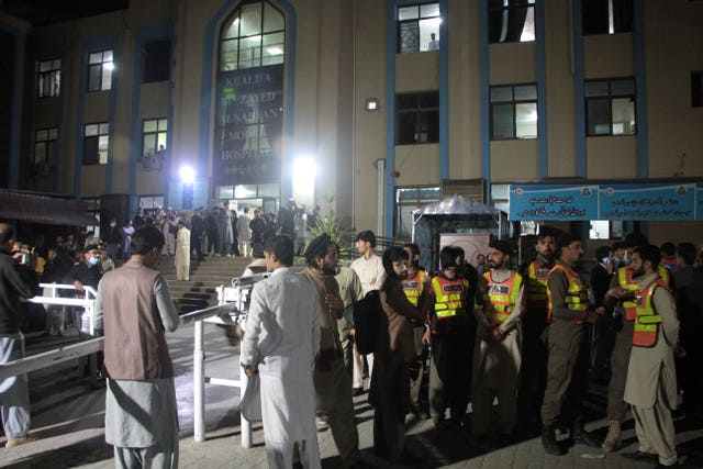 Rescue workers and people gather at a hospital where earthquake victims are brought, in Saidu Sharif, a town Pakistan’s Swat valley, Tuesday, March 21, 2023