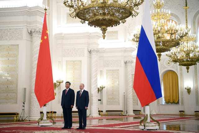 Mr Putin, right, and Mr Xi attend an official welcome ceremony at The Grand Kremlin Palace in Moscow 