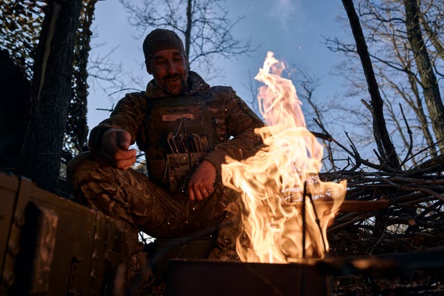 A Ukrainian soldier rests at their position on the frontline in Bakhmut 