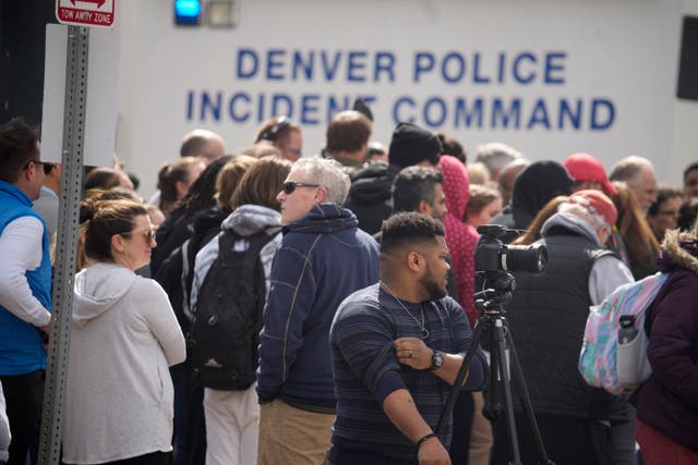 Parents wait for students at the school