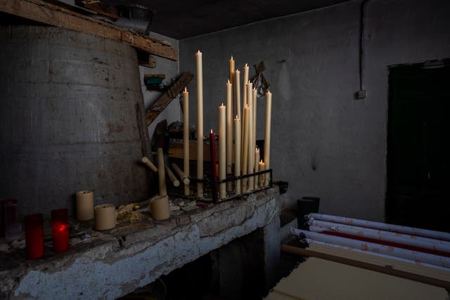 Candles burn at the Bellido candle factory in Andujar, southern Spain