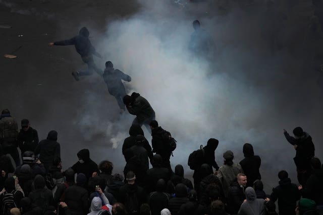 Protesters scuffle at the end of a rally in Paris
