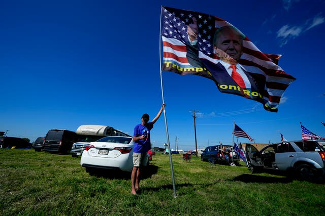 Rick Frazier, of Ohio, holds a large flag in Waco ahead of Donald Trump’s campaign rally