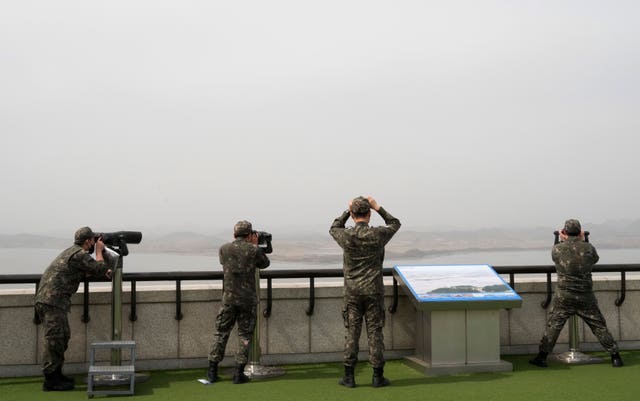 South Korean army soldiers watch the North Korea side from the Unification Observation Post in Paju, South Korea, near the border with North Korea