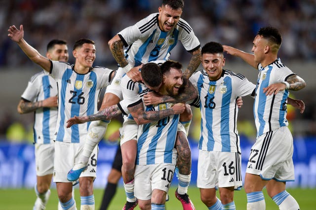 Argentina’s Lionel Messi (10) celebrates with teammates after scoring (Gustavo Garello/AP)