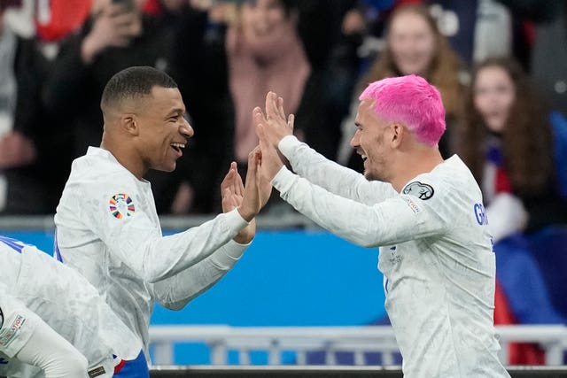 Antoine Griezmann, right, celebrates with Kylian Mbappe