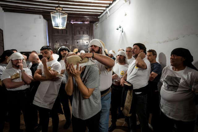 Porters of ‘Nuestro Padre Jesus del Gran Poder y la Esperanza Macarena’ brotherhood gather prior to practicing in downtown Madrid