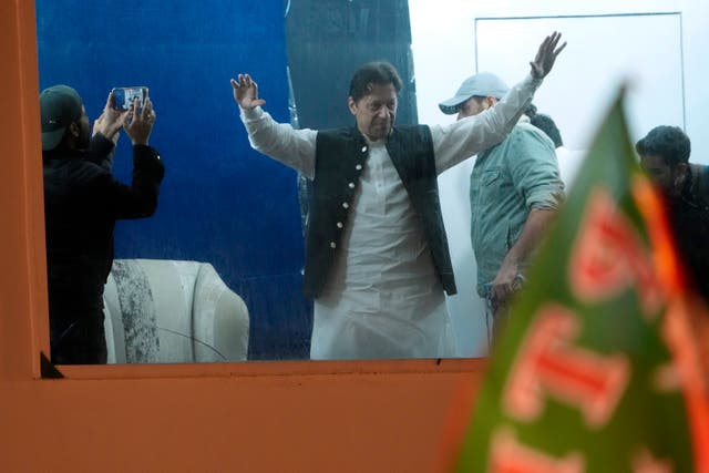Former prime minister Imran Khan waves to supporters during the rally 