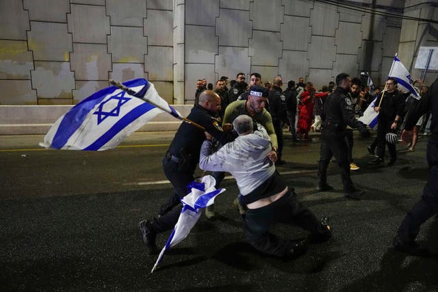 Israeli police scuffle with demonstrators blocking a motorway  in Tel Aviv during a protest against plans by Prime Minister Benjamin Netanyahu’s government to overhaul the judicial system