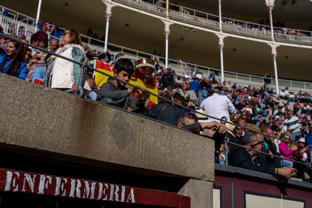 A child waits for the bullfight to begin at Las Ventas bullring in Madrid, Spain
