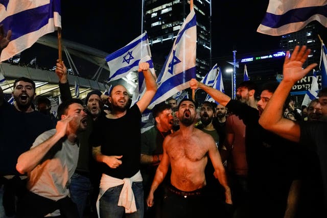 Israelis opposed to Prime Minister Benjamin Netanyahu’s judicial overhaul plan block a motorway during a protest moments after the Israeli leader fired his defence minister, in Tel Aviv, Israel