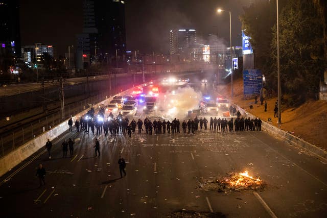 Israeli police disperse demonstrators blocking a motorway during a protest against plans by Prime Minister Benjamin Netanyahu’s government to overhaul the judicial system in Tel Aviv, Israel