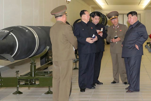 North Korean leader Kim Jong Un, right, talks with military officials (Korean Central News Agency/Korea News Service via AP)