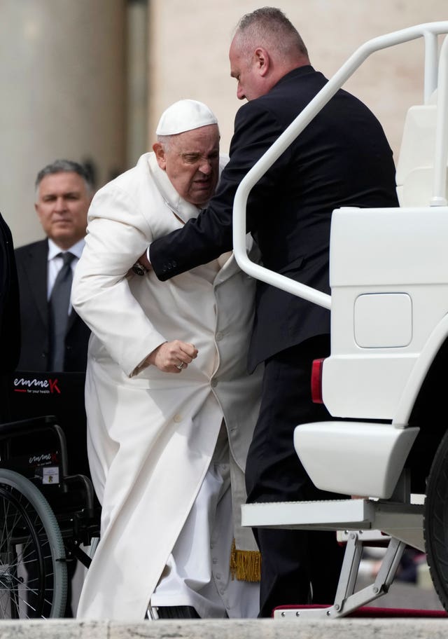 Pope Francis is helped to get into his car at the end of the weekly general audience in St Peter’s Square, at the Vatican, on Wednesday March 29 2023