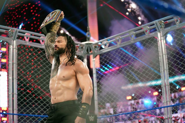Roman Reigns holds up the WWE Universal Championship after defeating Jey Uso during a match in 2020 in Orlando, Florida