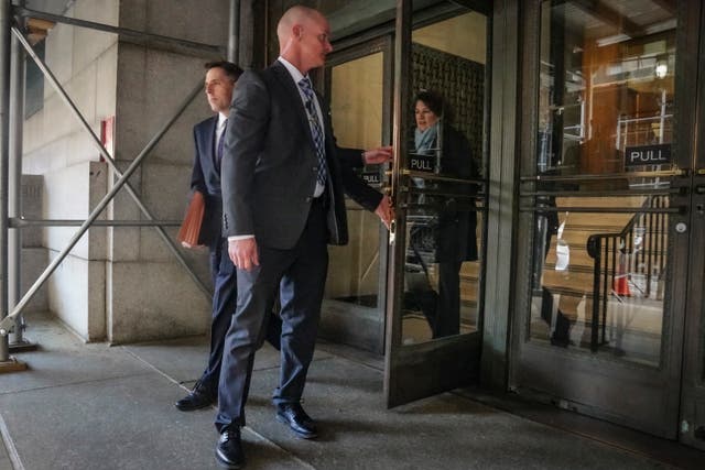 Prosecutors Matthew Colangelo, left, and Susan Hoffinger, right, leave a state office building in New York 