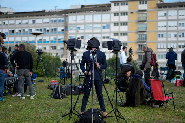 Members of the media set up their gear outside the Agostino Gemelli hospital