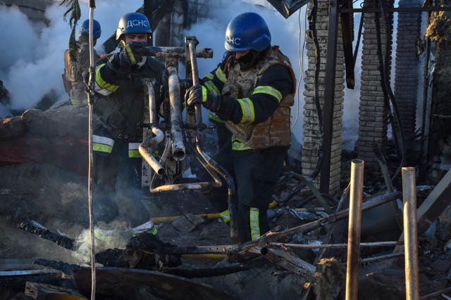 Members of the Ukrainian State Emergency Service clear the rubble at a building destroyed by a Russian strike in the Zaporizhzhia district, Ukraine