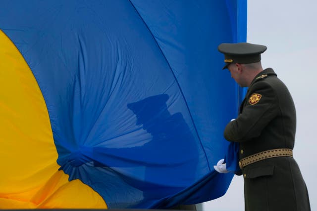 Ukrainian honour guard soldiers take part in a national flag-raising ceremony during a commemorative event on the anniversary of the liberation of the territories from the Russian troops, in Bucha, on the outskirts of Kyiv, Ukraine, on Friday March 31 2023