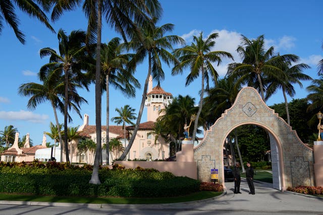 Security agents talk at the entrance to former president Donald Trump’s Mar-a-Lago estate in Palm Beach, Florida, in March