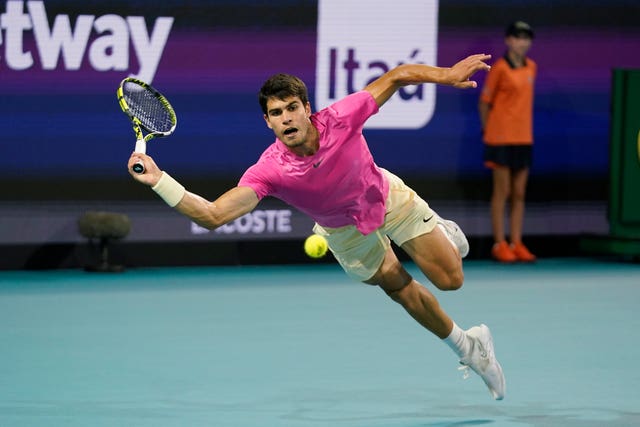 Carlos Alcaraz dives for a forehand