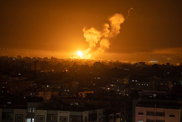 Fire and smoke rise following an Israeli air strike in the central Gaza Strip