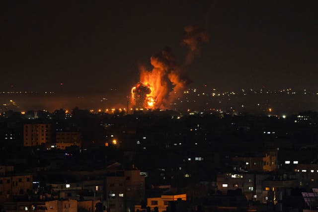 Fire and smoke rise following an Israeli air strike in the central Gaza Strip