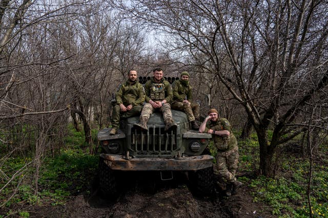 Ukrainian servicemen sit on their vehicle, on the front line in the Donetsk region, Ukraine